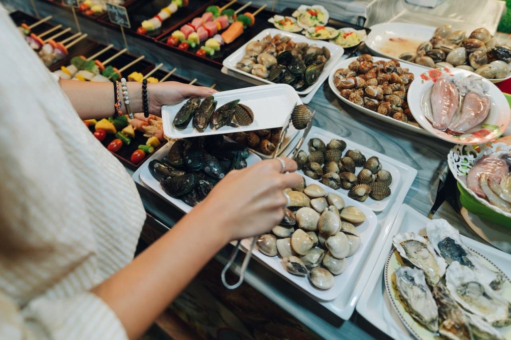 Person Getting A Shellfish What Eats Shellfish